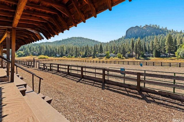 view of stable featuring a mountain view and a rural view