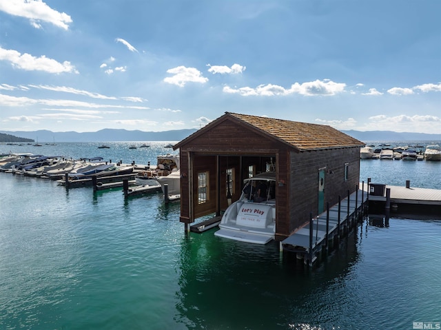 view of dock with a water and mountain view