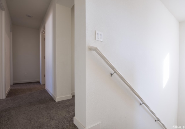 hallway featuring dark carpet