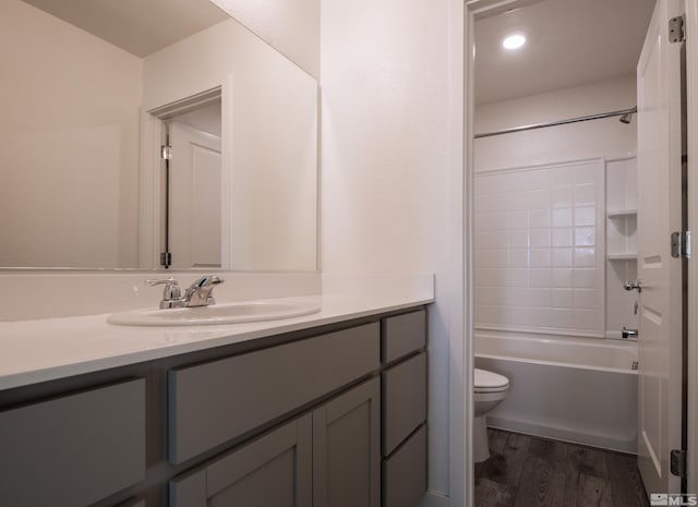 full bathroom featuring vanity, toilet, hardwood / wood-style flooring, and shower / bathtub combination