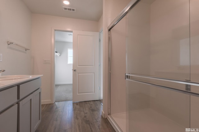 bathroom featuring vanity, a shower with door, and hardwood / wood-style floors