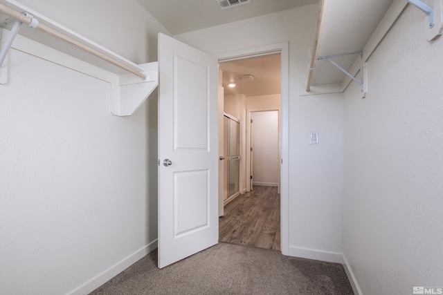 spacious closet with hardwood / wood-style floors