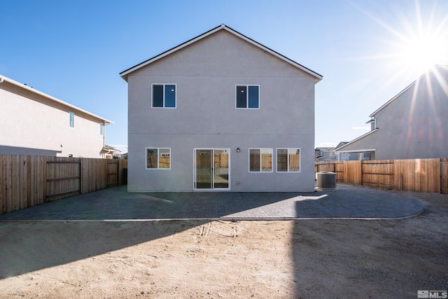 rear view of house featuring a patio area and central AC unit