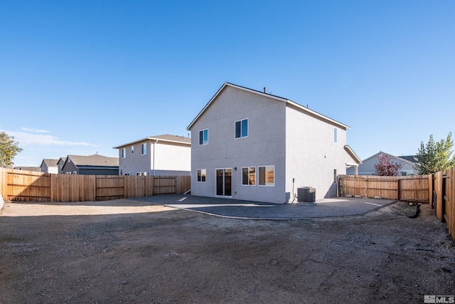 back of property with a patio and central AC unit