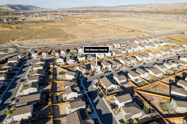 birds eye view of property with a mountain view