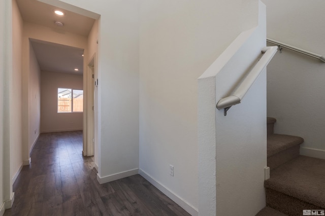 staircase with hardwood / wood-style floors