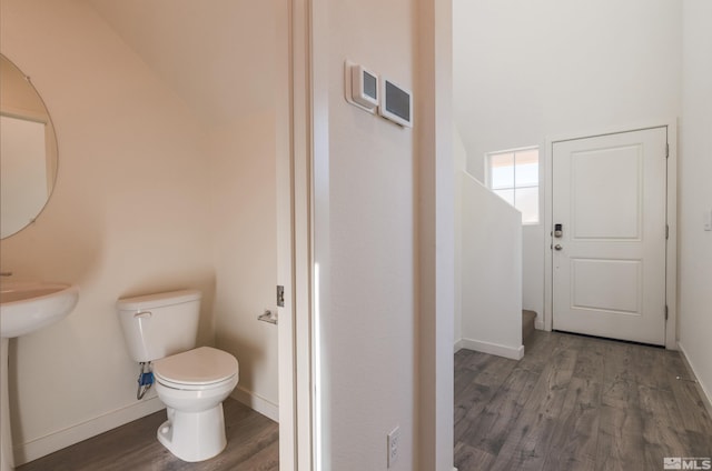 bathroom with hardwood / wood-style floors and toilet