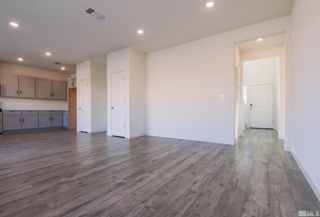 unfurnished living room with dark hardwood / wood-style flooring