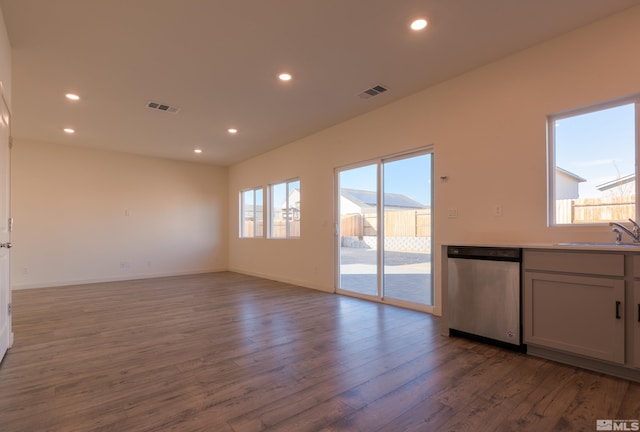 unfurnished living room featuring light hardwood / wood-style floors and sink