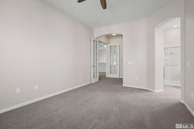 carpeted spare room with french doors and ceiling fan