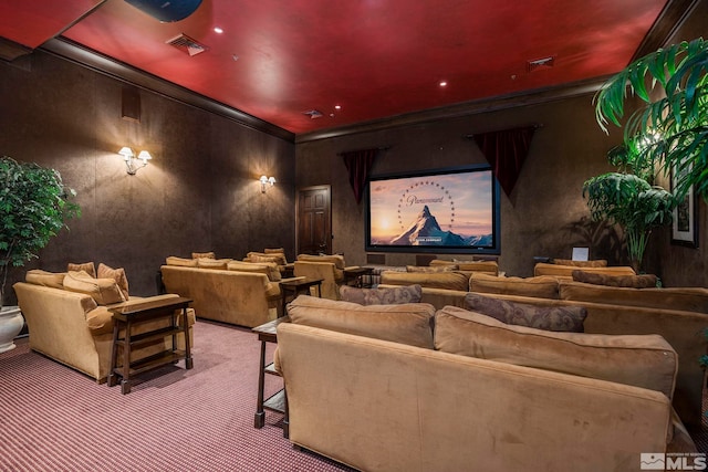 carpeted home theater room with ornamental molding