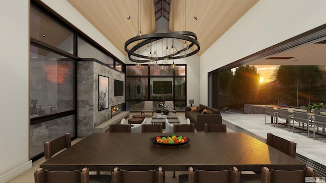 dining room featuring a towering ceiling and an inviting chandelier