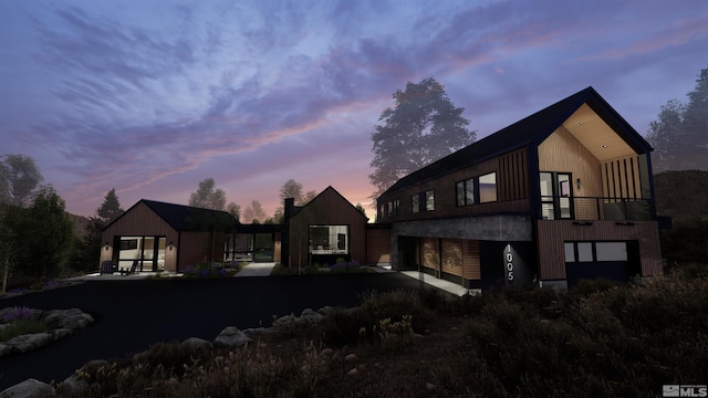 back house at dusk with a balcony