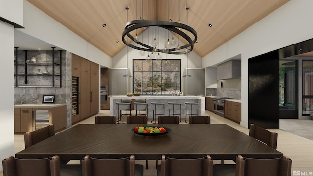 dining area featuring high vaulted ceiling and a chandelier