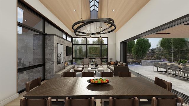 dining space featuring a towering ceiling and a notable chandelier