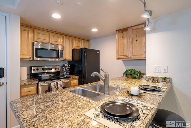 kitchen featuring light brown cabinetry, sink, kitchen peninsula, and stainless steel appliances