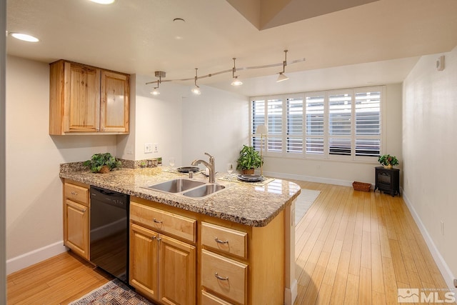 kitchen featuring sink, dishwasher, kitchen peninsula, and light hardwood / wood-style floors