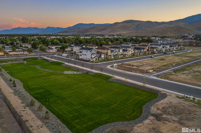 aerial view at dusk featuring a mountain view