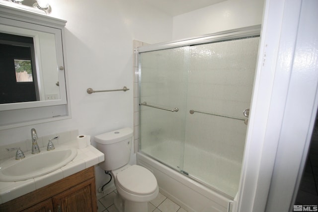 full bathroom featuring vanity, toilet, tile patterned floors, and enclosed tub / shower combo