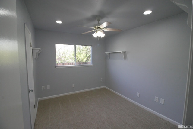 spare room with ceiling fan and carpet floors