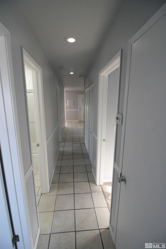 hall featuring light tile patterned floors