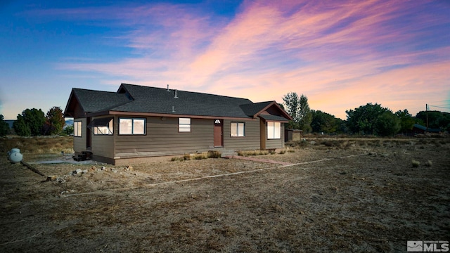 view of back house at dusk