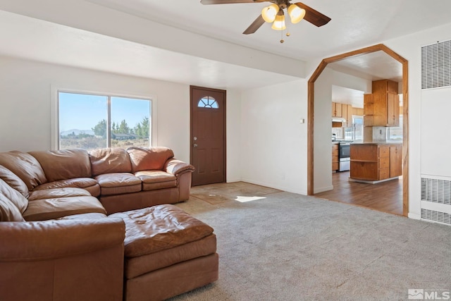 living room featuring ceiling fan and light wood-type flooring