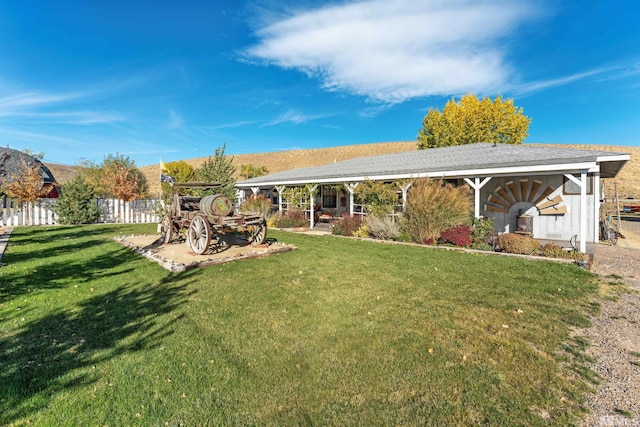 rear view of property featuring a patio and a lawn