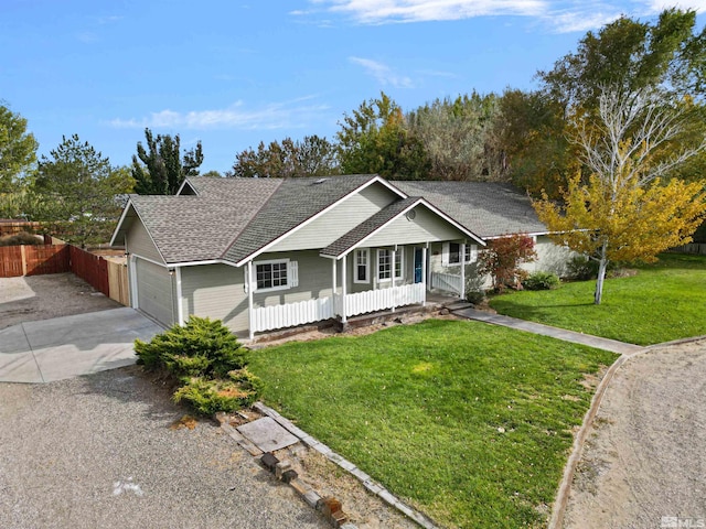 single story home with covered porch, a front lawn, and a garage