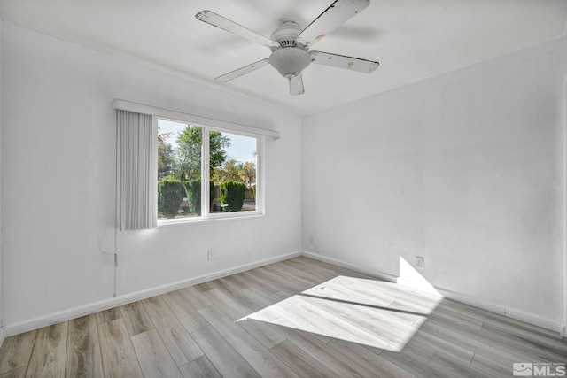 empty room featuring light wood-type flooring and ceiling fan