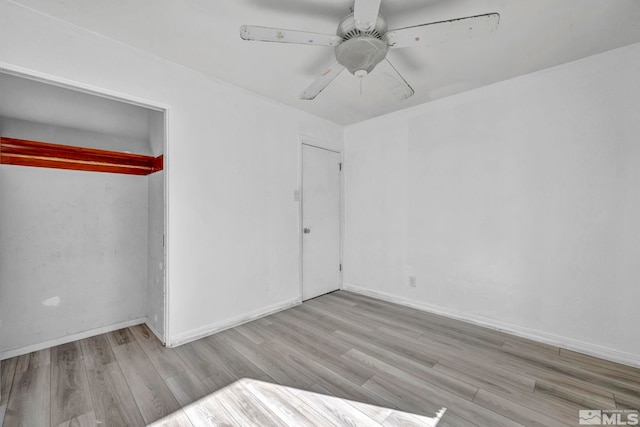 unfurnished bedroom featuring a closet, ceiling fan, and light wood-type flooring