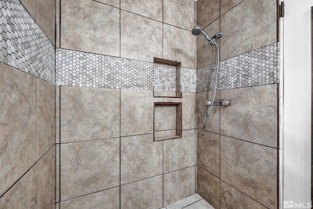 interior details with a tile shower