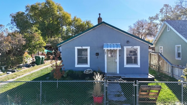 bungalow-style house with a front yard