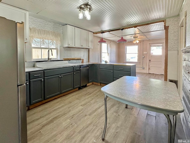 kitchen featuring gray cabinetry, a healthy amount of sunlight, appliances with stainless steel finishes, and sink