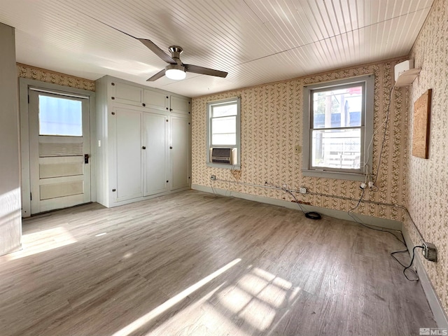 unfurnished bedroom featuring light wood-type flooring and ceiling fan