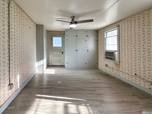 unfurnished bedroom featuring light hardwood / wood-style flooring, wooden ceiling, and ceiling fan