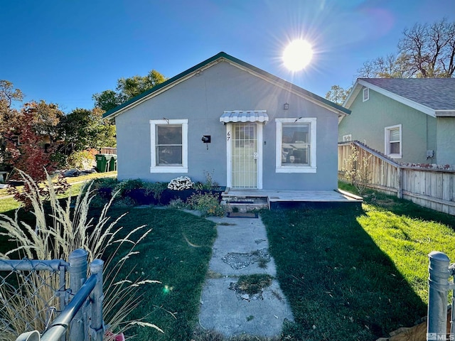 bungalow-style house featuring a front yard