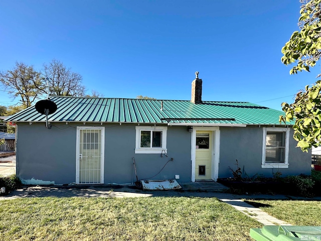 rear view of house with a yard