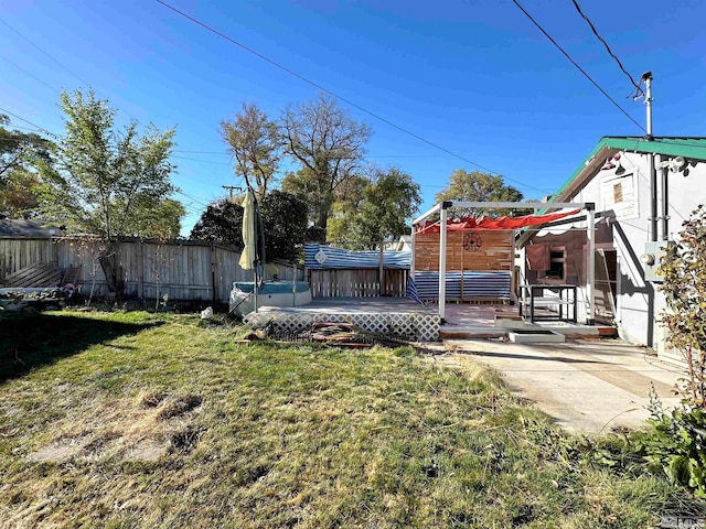 view of yard featuring a patio area and a deck