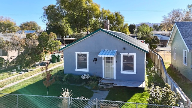 bungalow-style house featuring a front yard