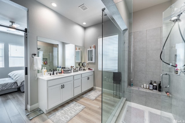 bathroom featuring vanity, hardwood / wood-style floors, and a shower with shower door