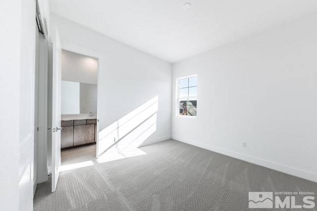 spare room with light colored carpet