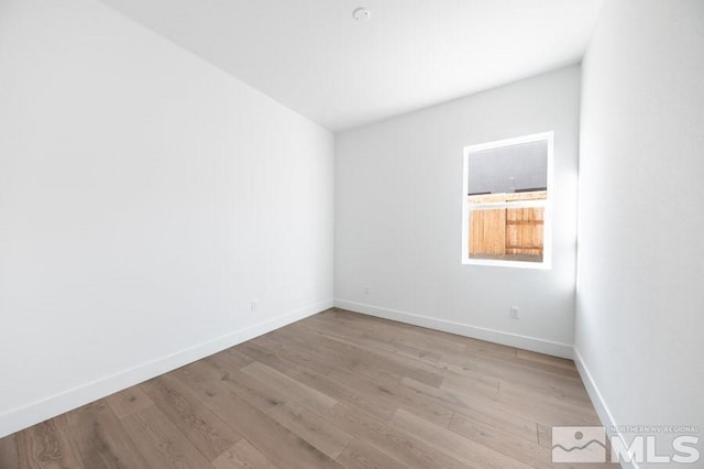 spare room with light hardwood / wood-style flooring