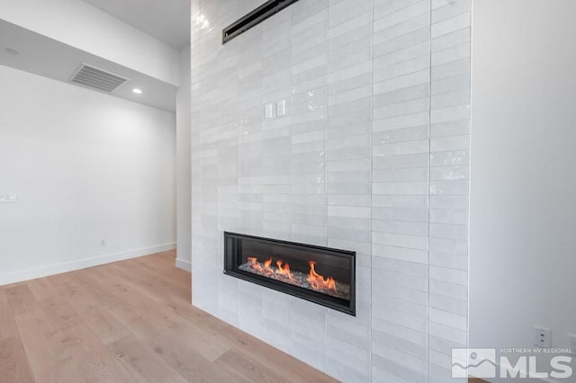 room details with hardwood / wood-style floors and a fireplace