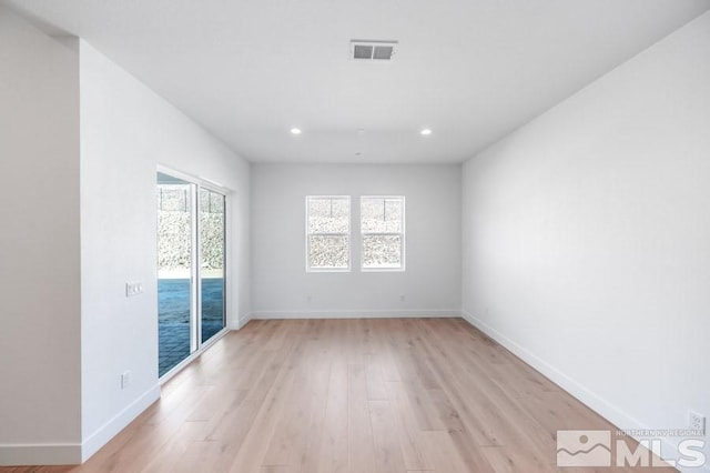 empty room with light hardwood / wood-style floors