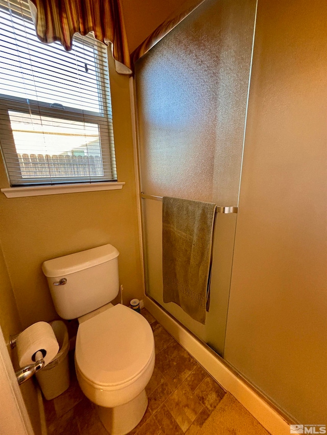 bathroom with toilet and walk in shower