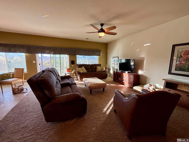 carpeted living room featuring ceiling fan and plenty of natural light