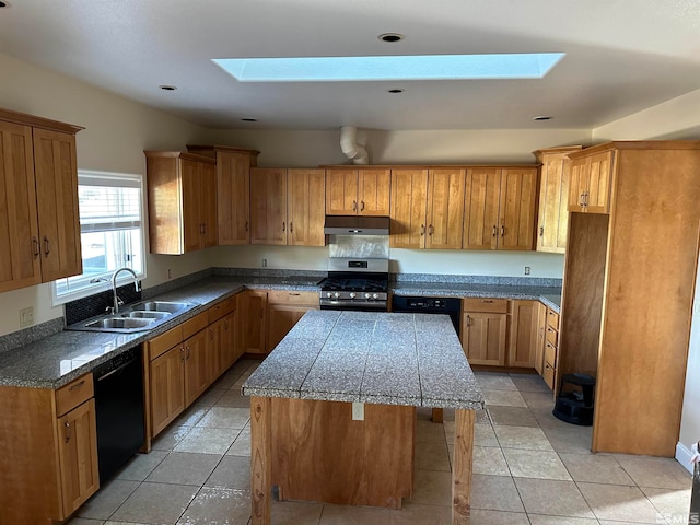 kitchen featuring stainless steel gas range oven, black dishwasher, a kitchen island, light tile patterned flooring, and sink