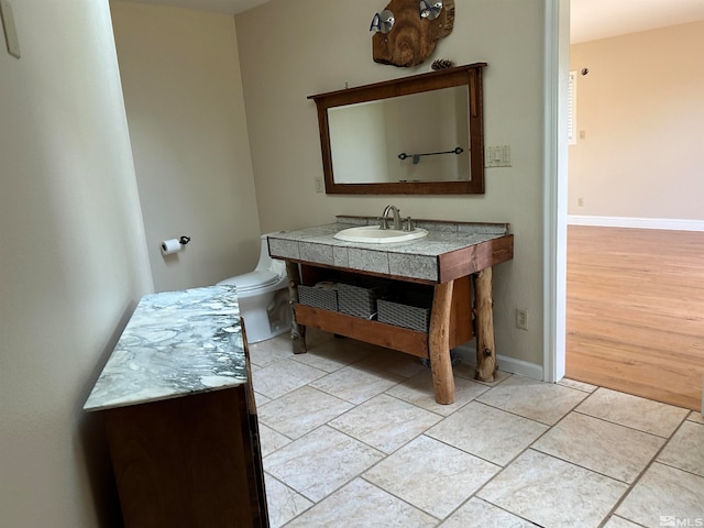 bathroom with vanity, toilet, and hardwood / wood-style flooring