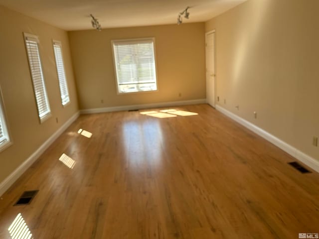 unfurnished room with hardwood / wood-style floors